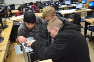 Students reassembling a computer as part of a club competition